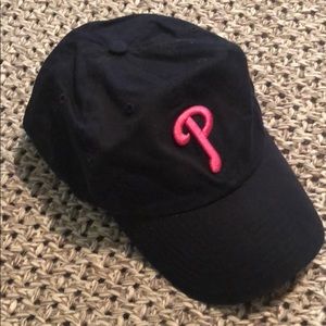 Black and pink Phillies cap.